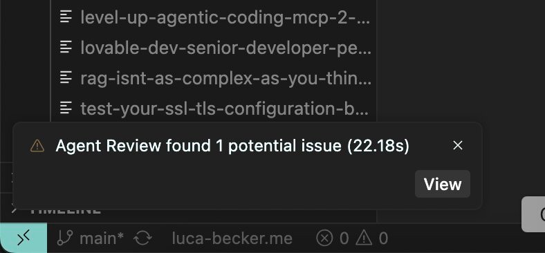 Cursor's review notification: a subtle toast in the bottom left corner with low contrast, showing 'Agent Review found 1 potential issue'